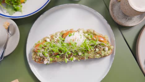 zoom out of healthy danish breakfast - toast served with side salads and coffee