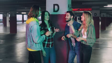 caucasian young stylish cheerful friends talking and laughing in a empty parking