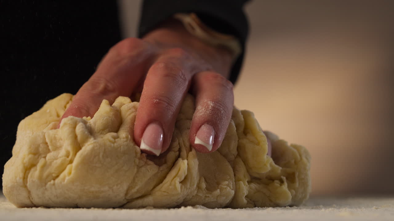 Sprinkling Flour On Surface Before Kneading Dough For Cinnamon Rolls. closeup, slow motion