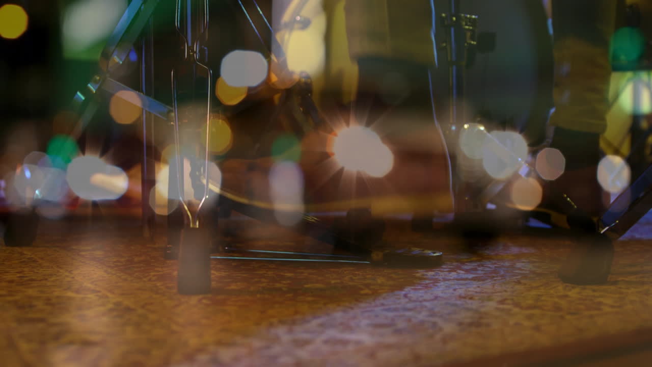 Boots pressing bass drum pedal over patterned rug in flat design scene, featuring glowing bokeh