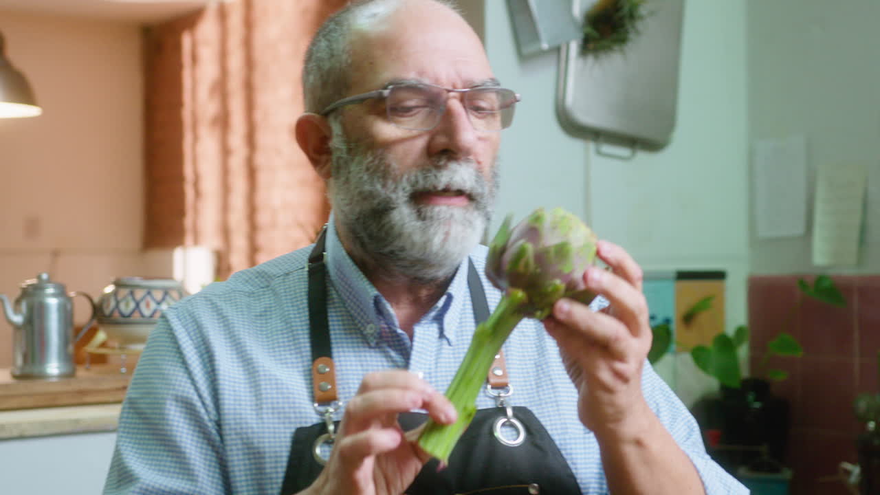 A man holding an artichoke