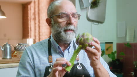 a man holding an artichoke