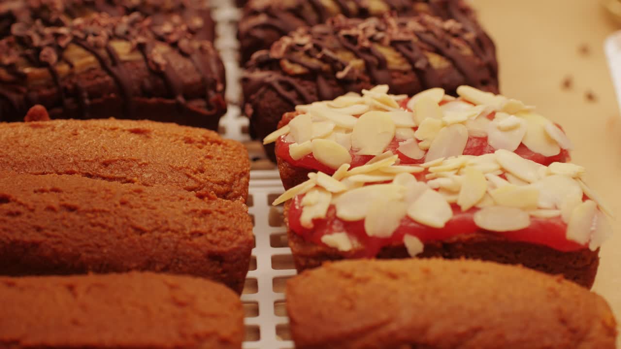Artezan bread with red strawberry jam on top, fresh bake double chocolate banana artesian bread in bakery shop close-up. Artisan bread is making by skill bakers using natural and high-quality ingredients. Food with health and flavour benefits. Sweet breads for dessert and breakfast