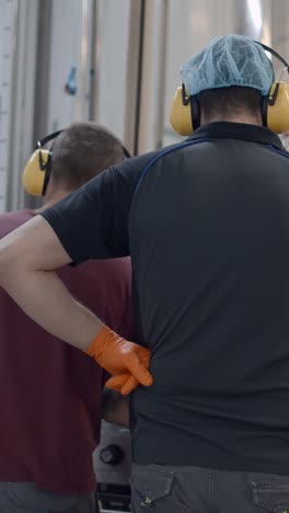 workers in an industrial setting with safety gear