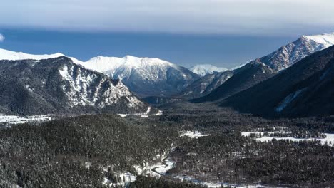 air flight through mountain clouds over beautiful snow-capped peaks of mountains and glaciers.