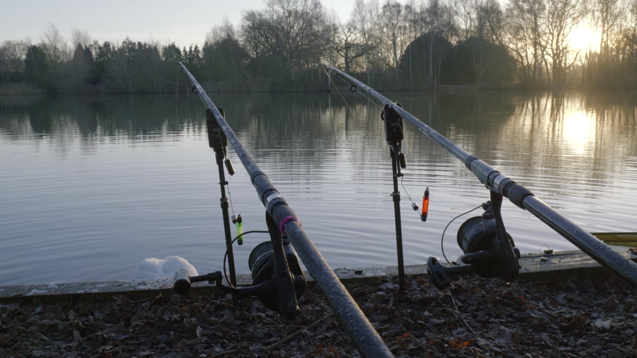Serene evening fishing at Bilingford Lake with rods in calm water