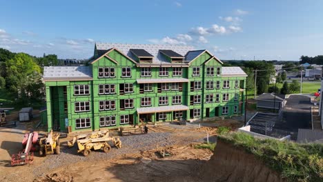 construction site with apartment building during building phase. aerial view. sunny day in subur area of american town