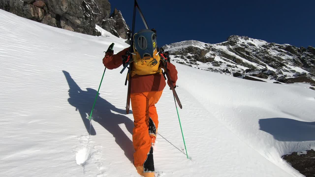 Professional mountaineer climping steep mountain in Tirol. Fresh powder hike 60 frames per second.