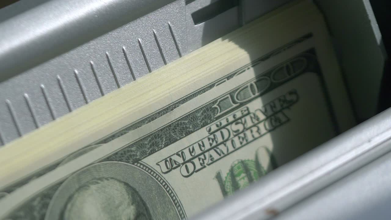 Machine counter automatic calculates a large amount of Dollar banknotes in 4K Slow motion 60fps