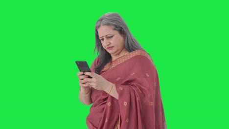 Angry-Indian-old-woman-chatting-on-phone-Green-screen