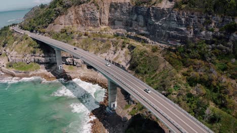 vehicles travelling at sea cliff bridge in summer at nsw, australia