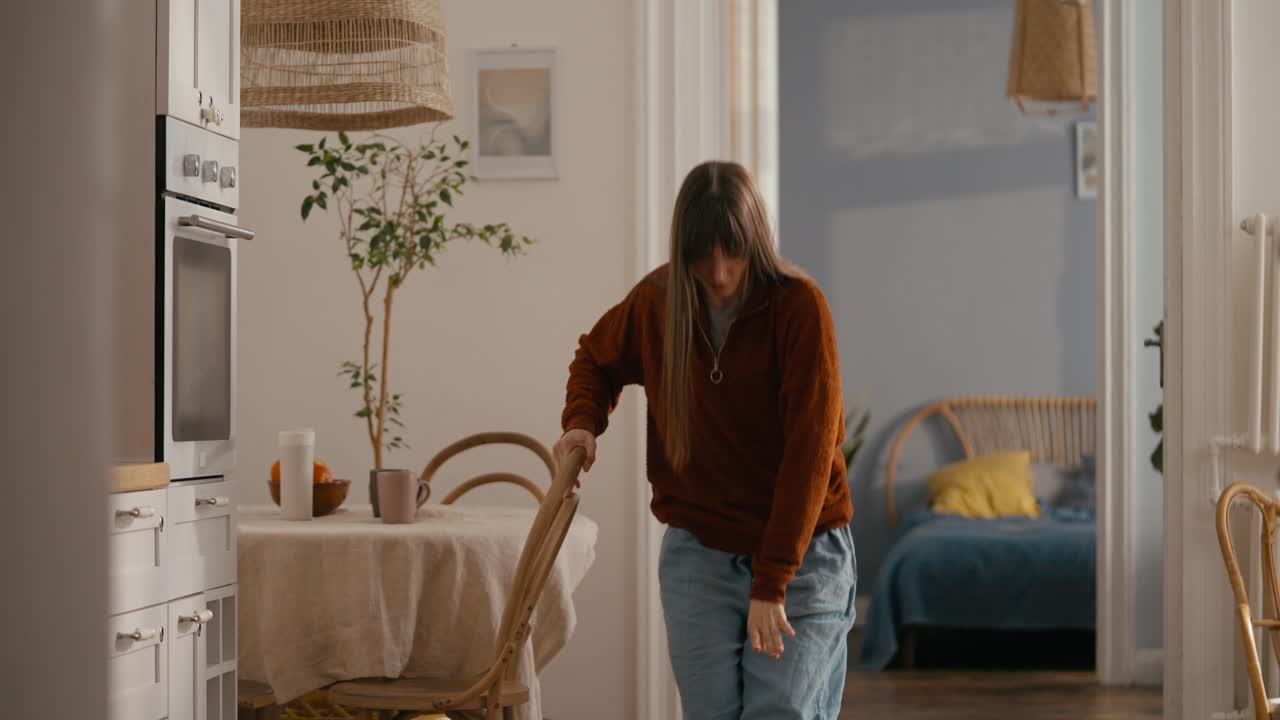 A woman dancing in her kitchen