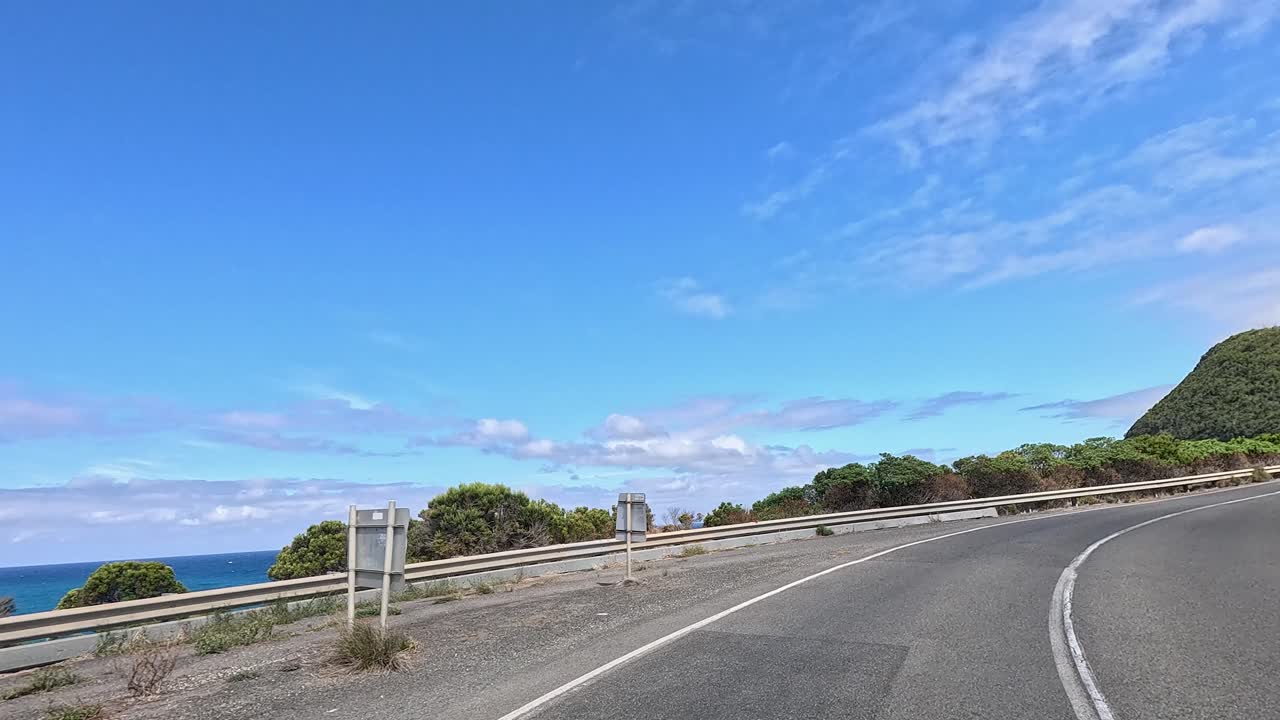 A 45-second journey showcasing winding roads, coastal views, and lush greenery under clear blue skies