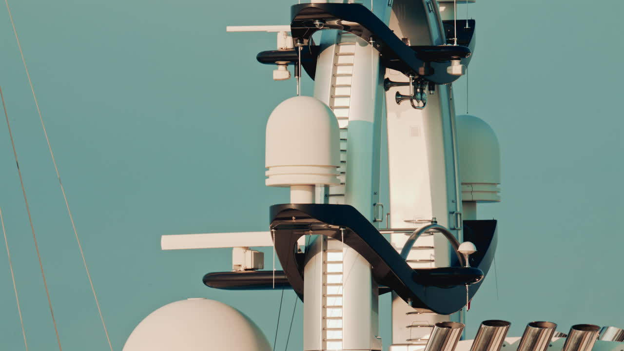The futuristic upper structure of a modern superyacht, featuring domes, antennas, and sleek white design elements