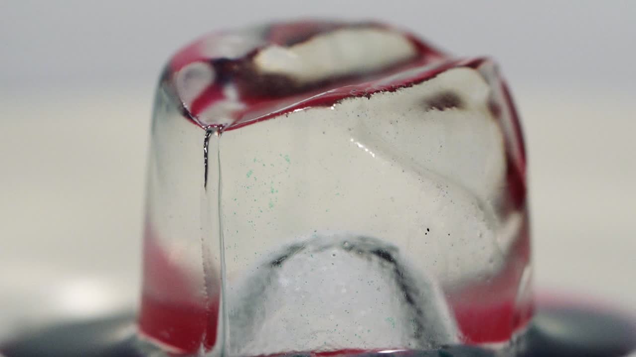 Slow motion paint falling on ice cube shot in macro. Sony a7iii