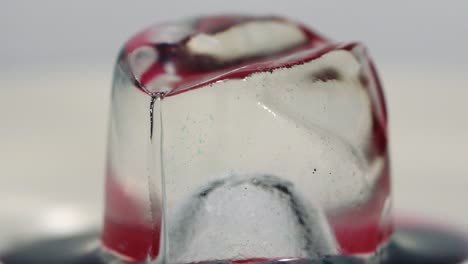 slow motion paint falling on ice cube shot in macro. sony a7iii