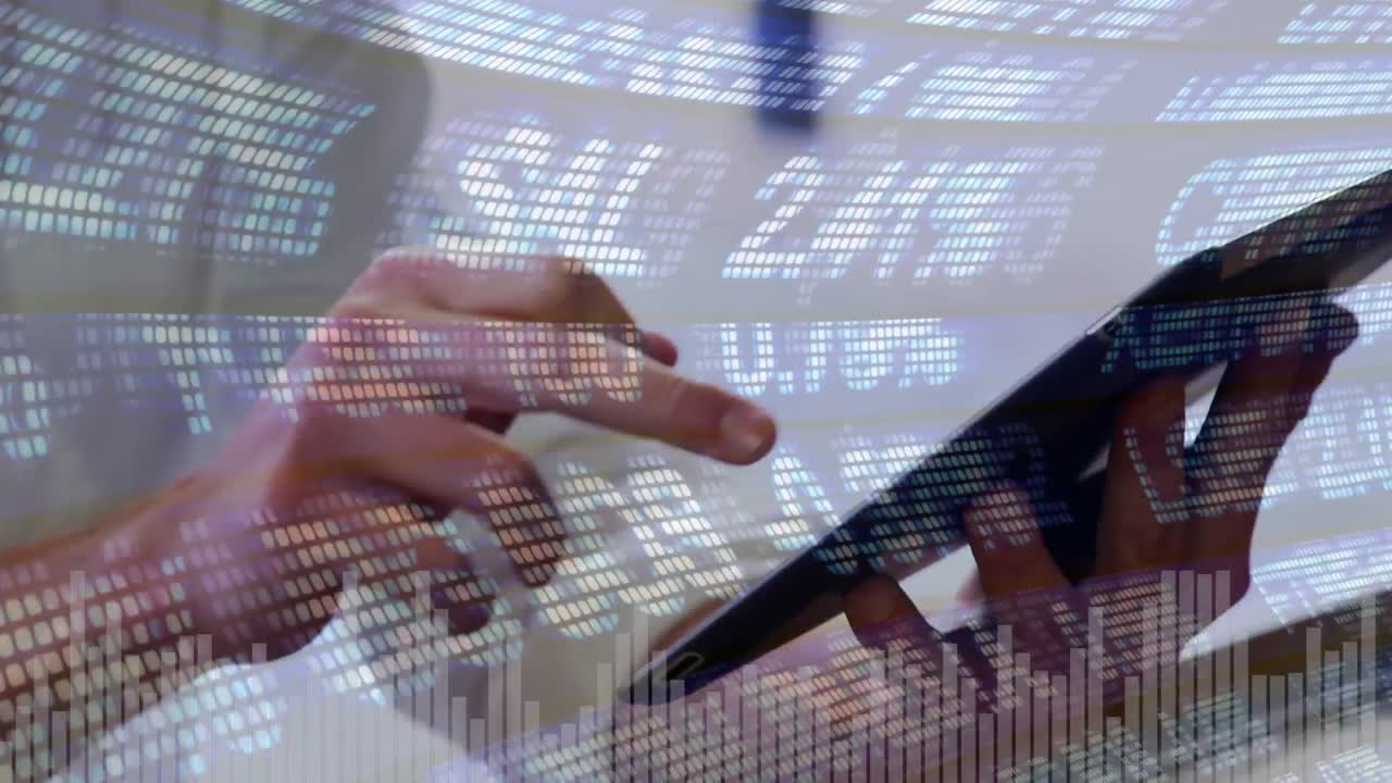 Man using a touchscreen tablet and economic values