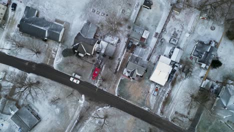 A-top-down-view-of-a-neighborhood-in-the-winter-with-a-light-dusting-of-snow-on-the-ground