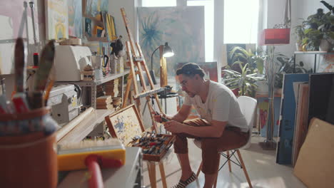 man sharpening pencil in art studio