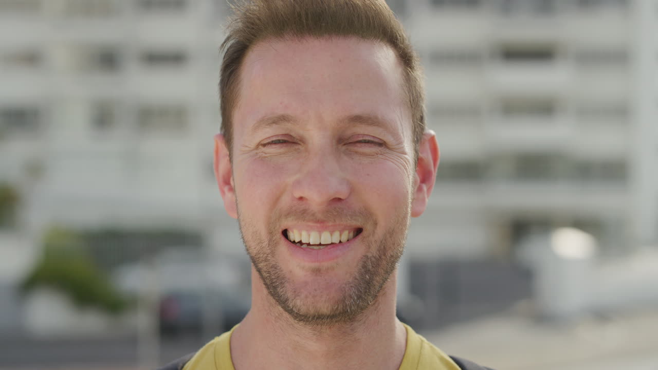 retrato de perto homem caucasiano atraente vira a cabeça sorrindo desfrutando de um estilo de vida relaxado homem independente feliz desfruta de um dia quente de verão na cidade urbana