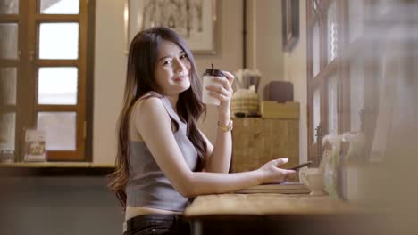 asian women drinking hot coffee in coffee shop.