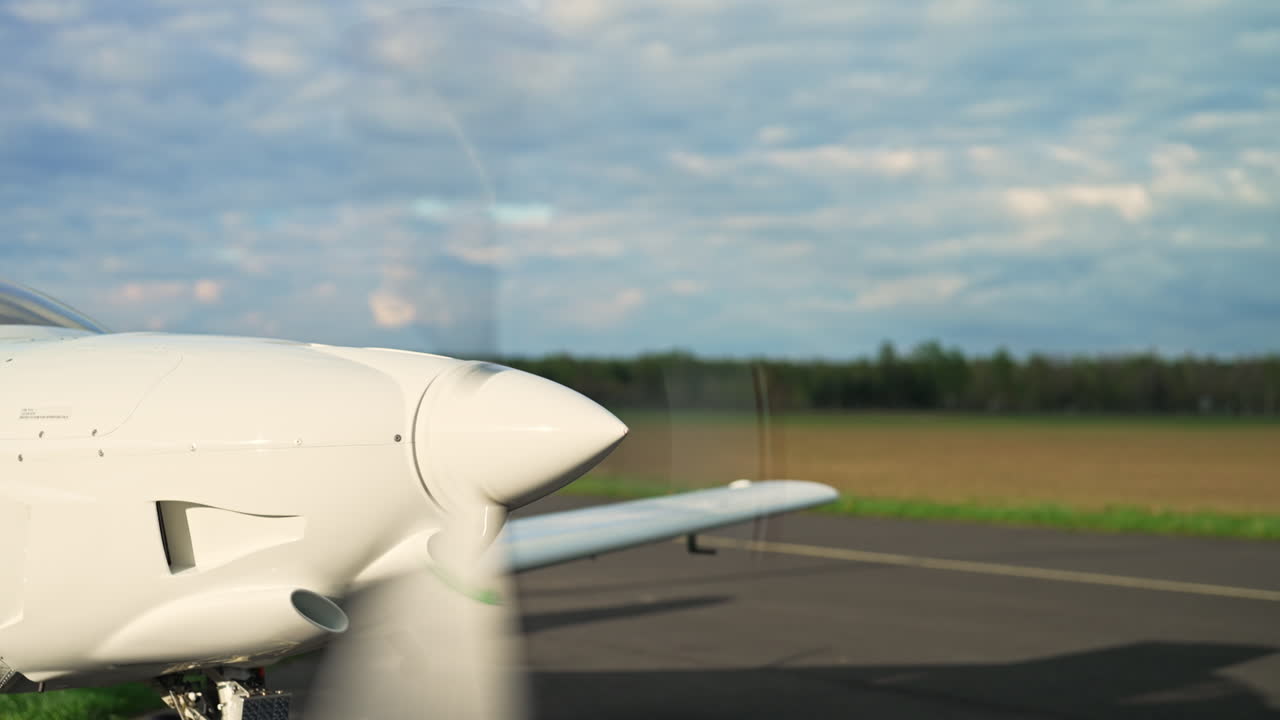 Aircraft engine turbine spinning rapidly on a runway, preparing for takeoff, starting and speeding up at stand still, medium static backdrop