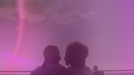 Animation-of-light-spots-over-african-american-couple-kissing-at-seaside