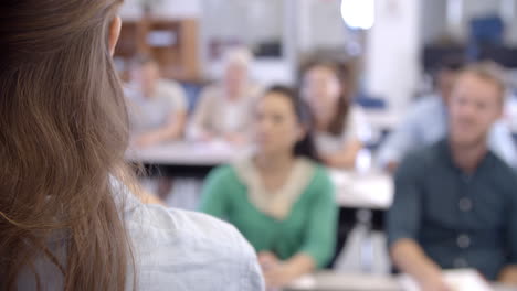 Vista-Por-Encima-Del-Hombro-Del-Profesor-Tomando-Clases-De-Educación-Para-Adultos