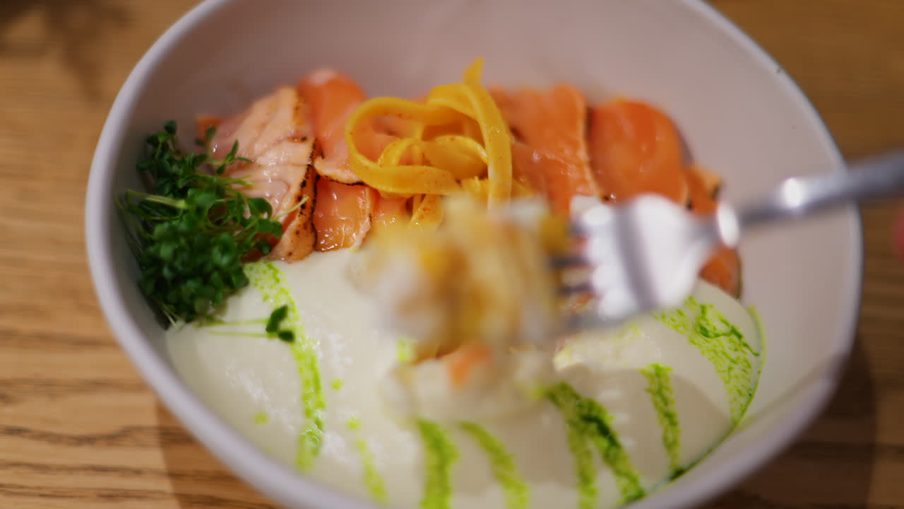 Close up of pasta with salmon and white sauce on a plate