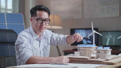 architect reviewing sustainable house design model