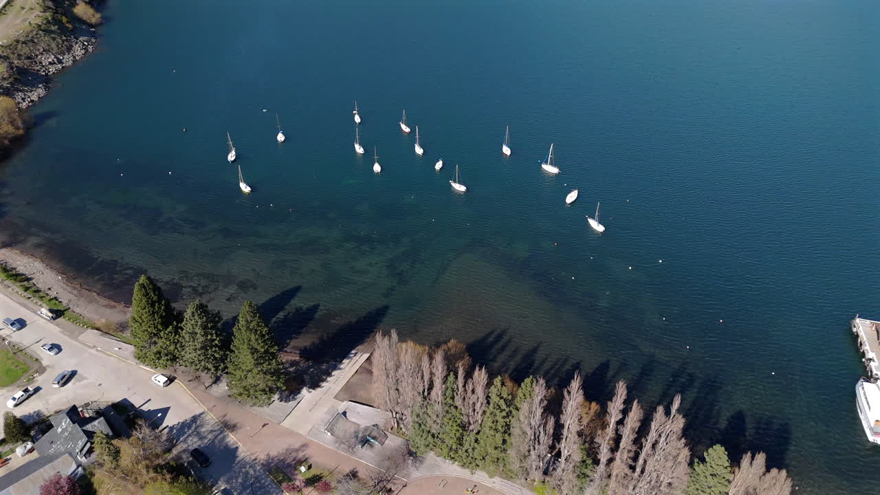 Aerial top view of sailboats in tourist village of San Martin de los Andes on Lake Lacar. Neuquen, Argentina.