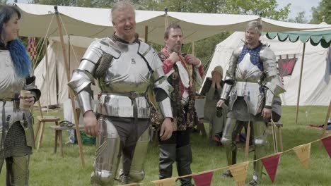 knights with their helmets off resting before taking part in the queen's joust at leeds castle, kent, england
