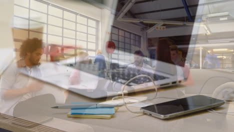animation of laptop over group of business people in office