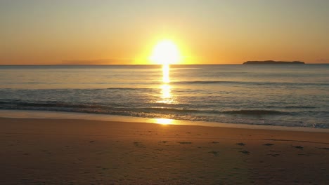 amazing tropical beach sunrise shining golden waves and steps in the sand