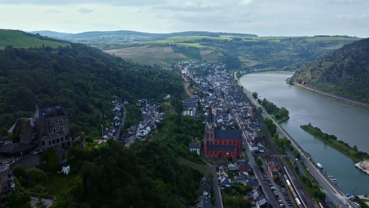 Wide aerial above Schoenburg castle and church of medieval Oberwesel town on German Rhine