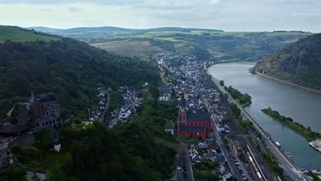 wide aerial above schoenburg castle and church of medieval oberwesel town on german rhine