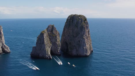 pleasure boats explore dramatic rock formations , capri