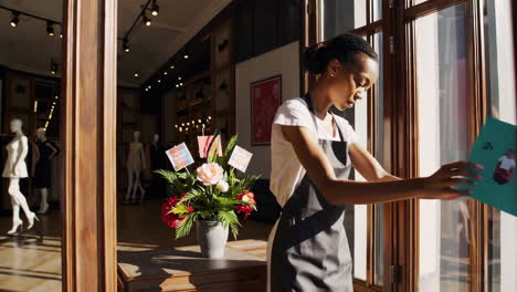 woman shop assistant opening shop door