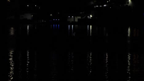 lights reflecting on the water of a lake at night, calm peaceful concept