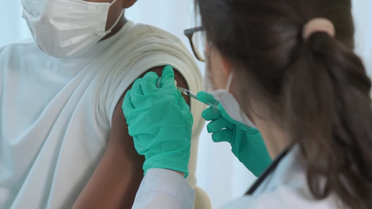 Young man visits skillful doctor at hospital for vaccination