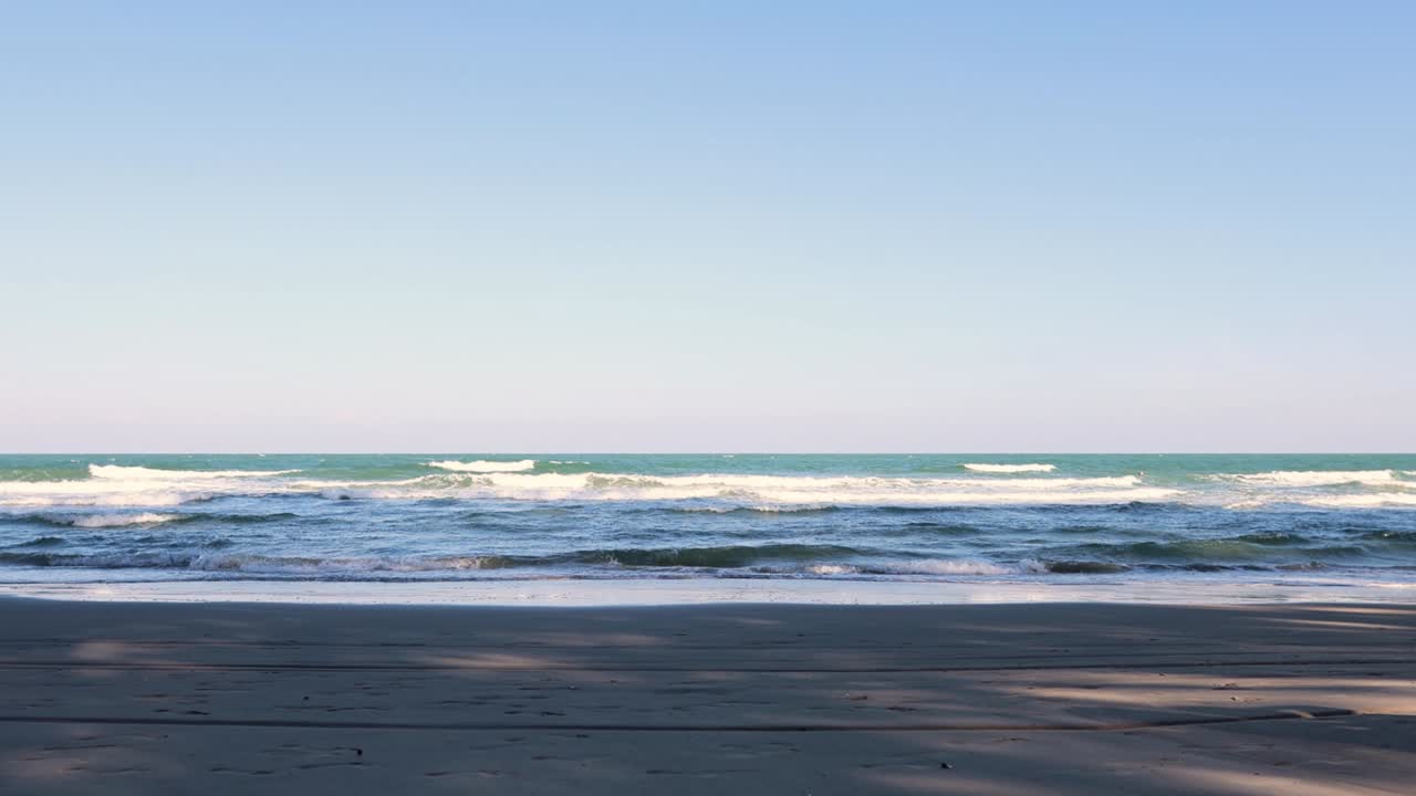 Calm ocean waves gently lapping a sandy shore