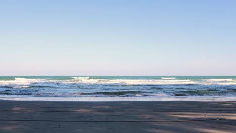 calm ocean waves gently lapping a sandy shore