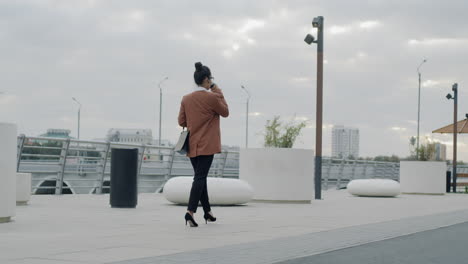 businesswoman walking in cityscape