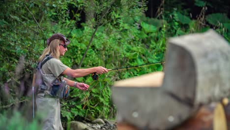 Long-hair-fisherman-fly-fishing-in-river,-wave-hand-Podvelka,-Slovenia,-slowmo