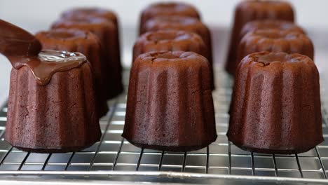 pastry chef topped chocolate on a canele.