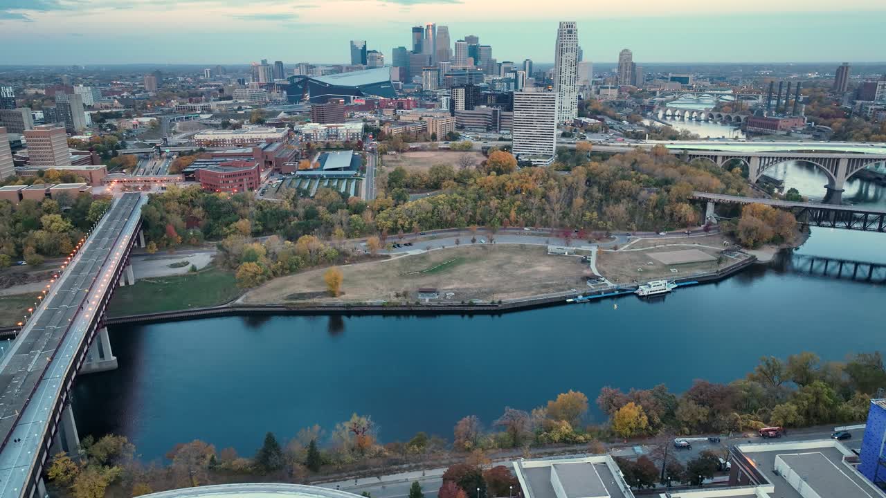 Drone footage capturing the Mississippi River, Minneapolis skyline, and historic Northern Pacific Bridge Number 9 in autumn