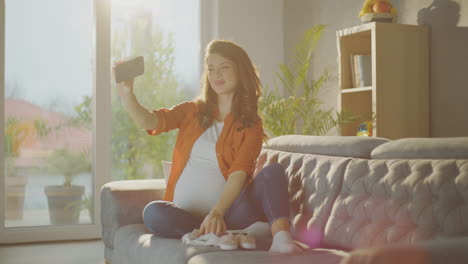 pregnant woman taking selfie with ultrasound photo