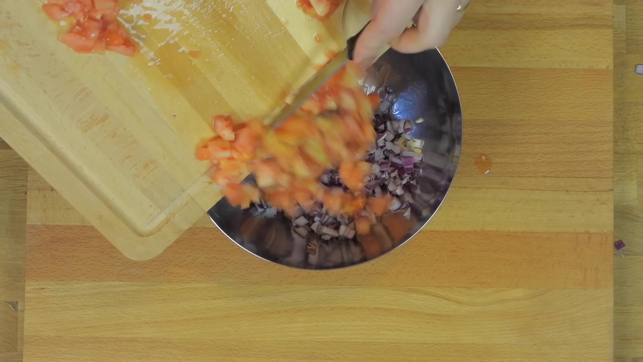 Person Dicing Fresh Tomato on Wooden Cutting Board