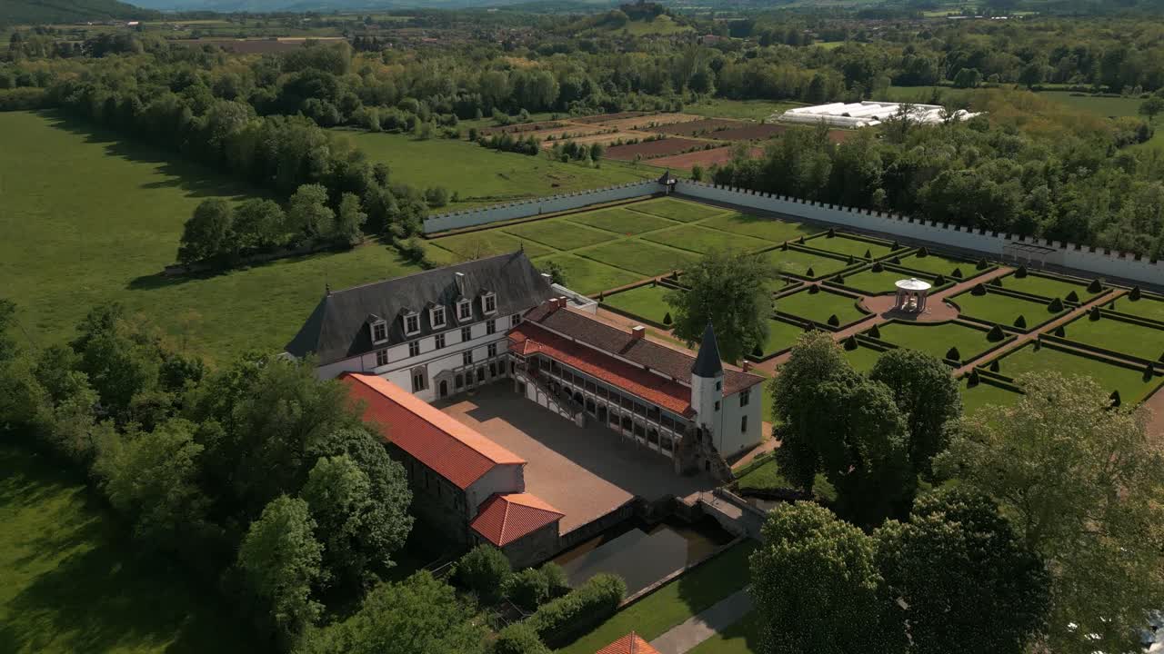 aerial shot above the Bastie d'Urfe castle in Forez plain on a sunny day in loire departement, auvergne rhone alpes region, France