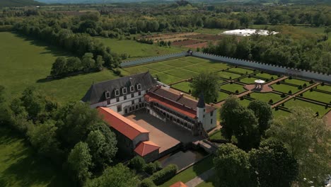 aerial shot above the bastie d'urfe castle in forez plain on a sunny day in loire departement, auvergne rhone alpes region, france